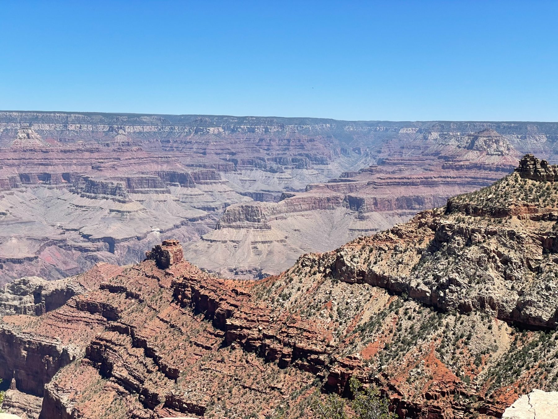 A wide canyon rim with layered desert cliffs