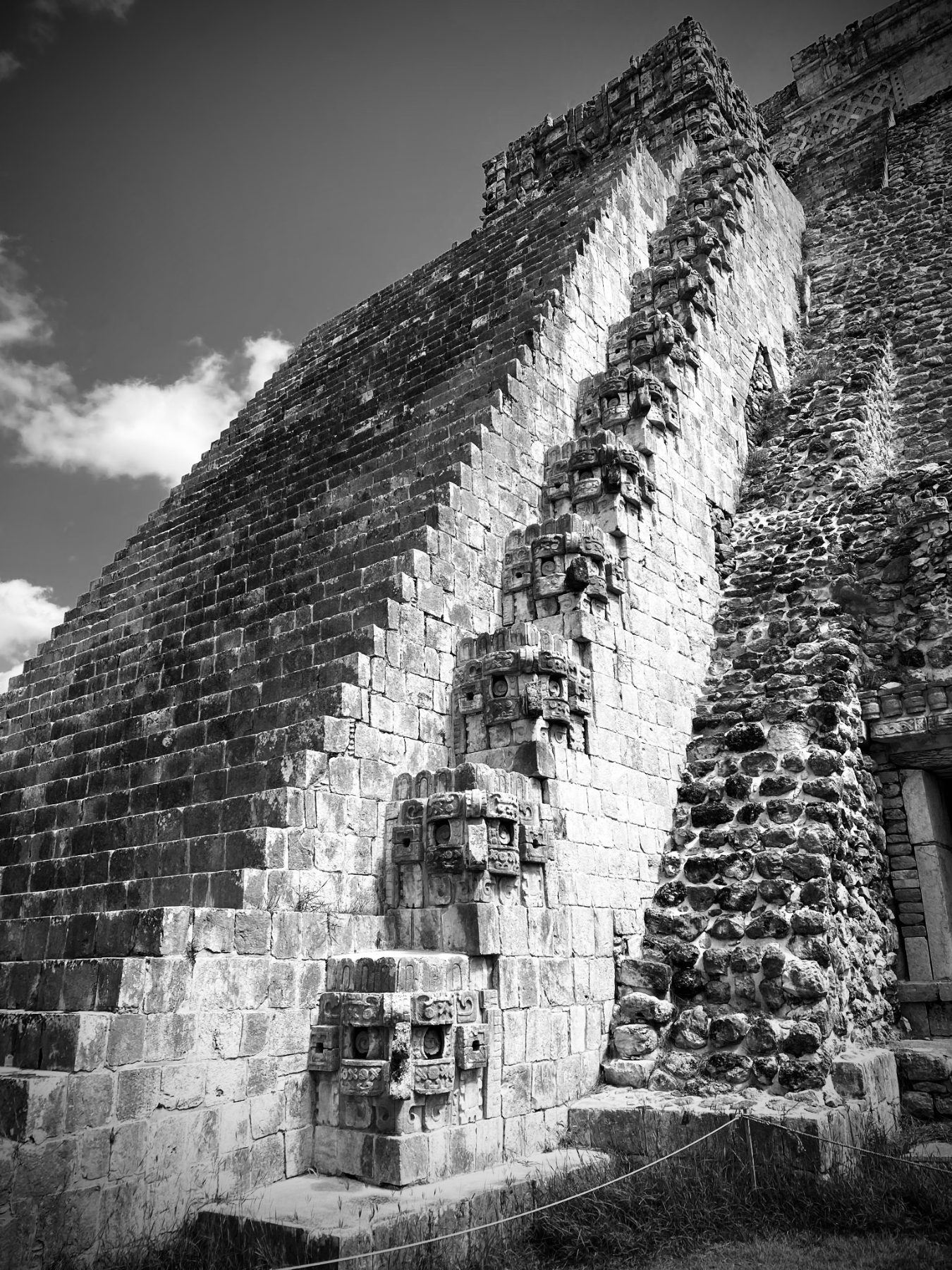 A Maya temple corner with stacked mask carvings